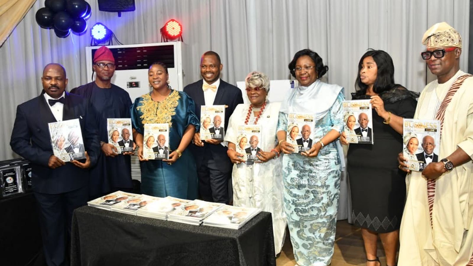 Honourees and guests holding the Business Magnet Magazine at a Get Elevated awards ceremony